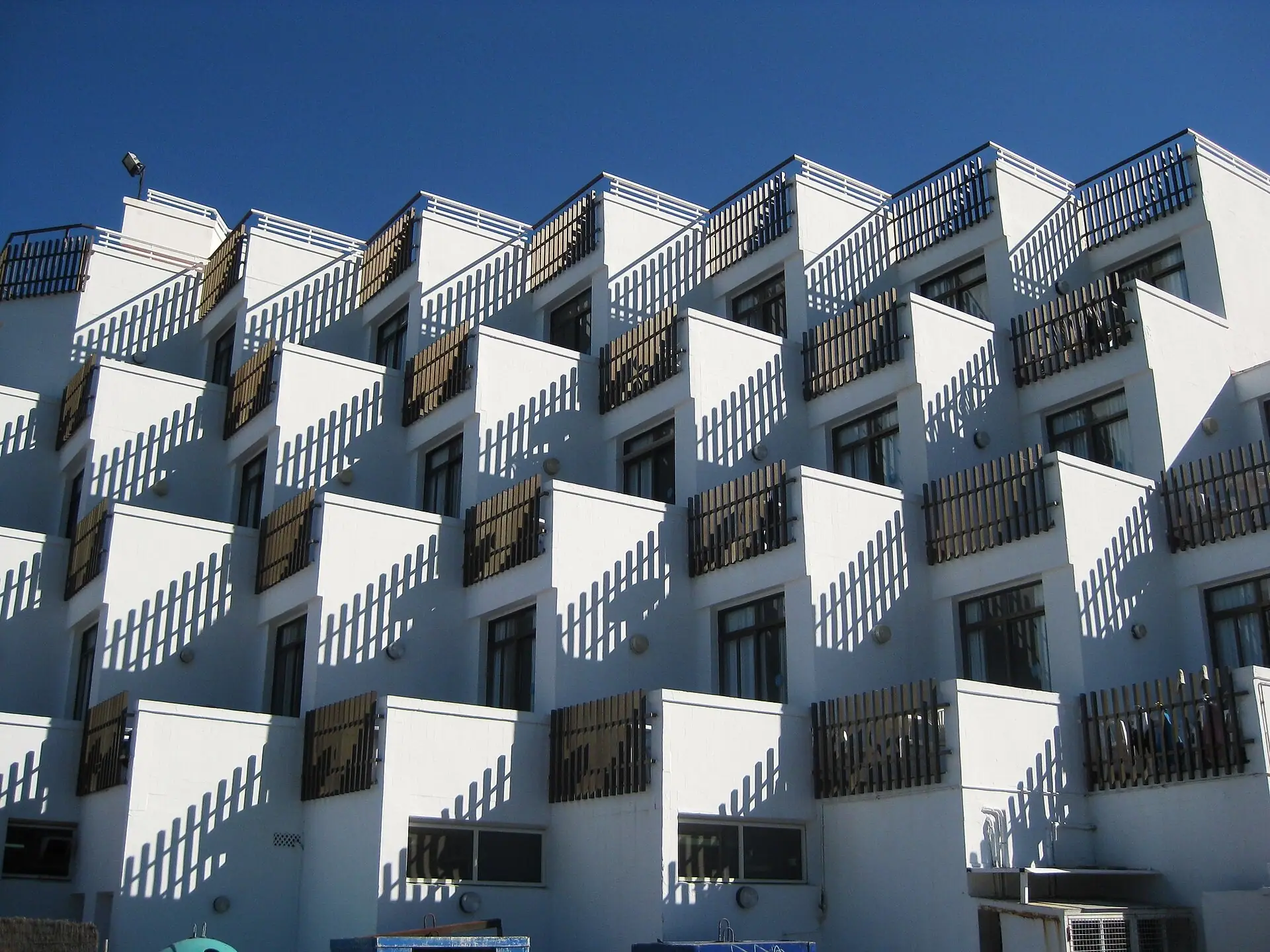 COURTYARD 26: kademeli beyaz kütleleri ve ahşap korkuluklu teraslarıyla konut cephesi (konsept görsel)